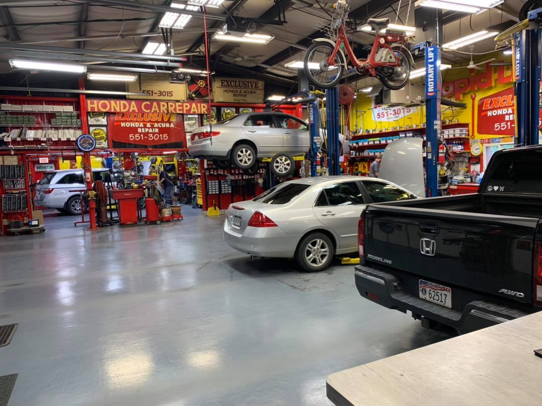 Cars on Lifts in the Exclusive East Auto Shop.